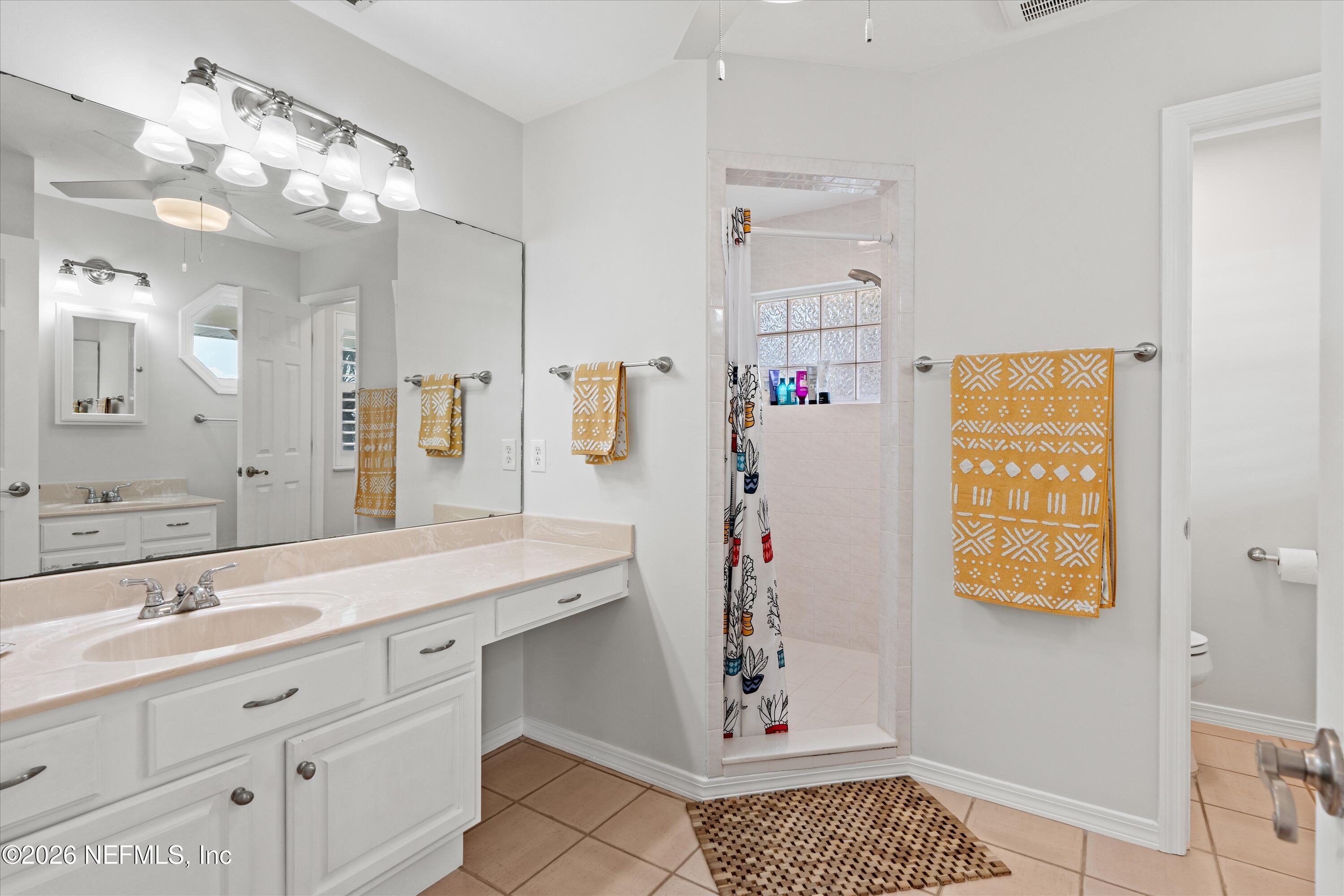 5532 Sunset Landing Circle St. Augustine, FL 32080 - Photo 35 of 43 a bathroom with a sink a vanity and a mirror