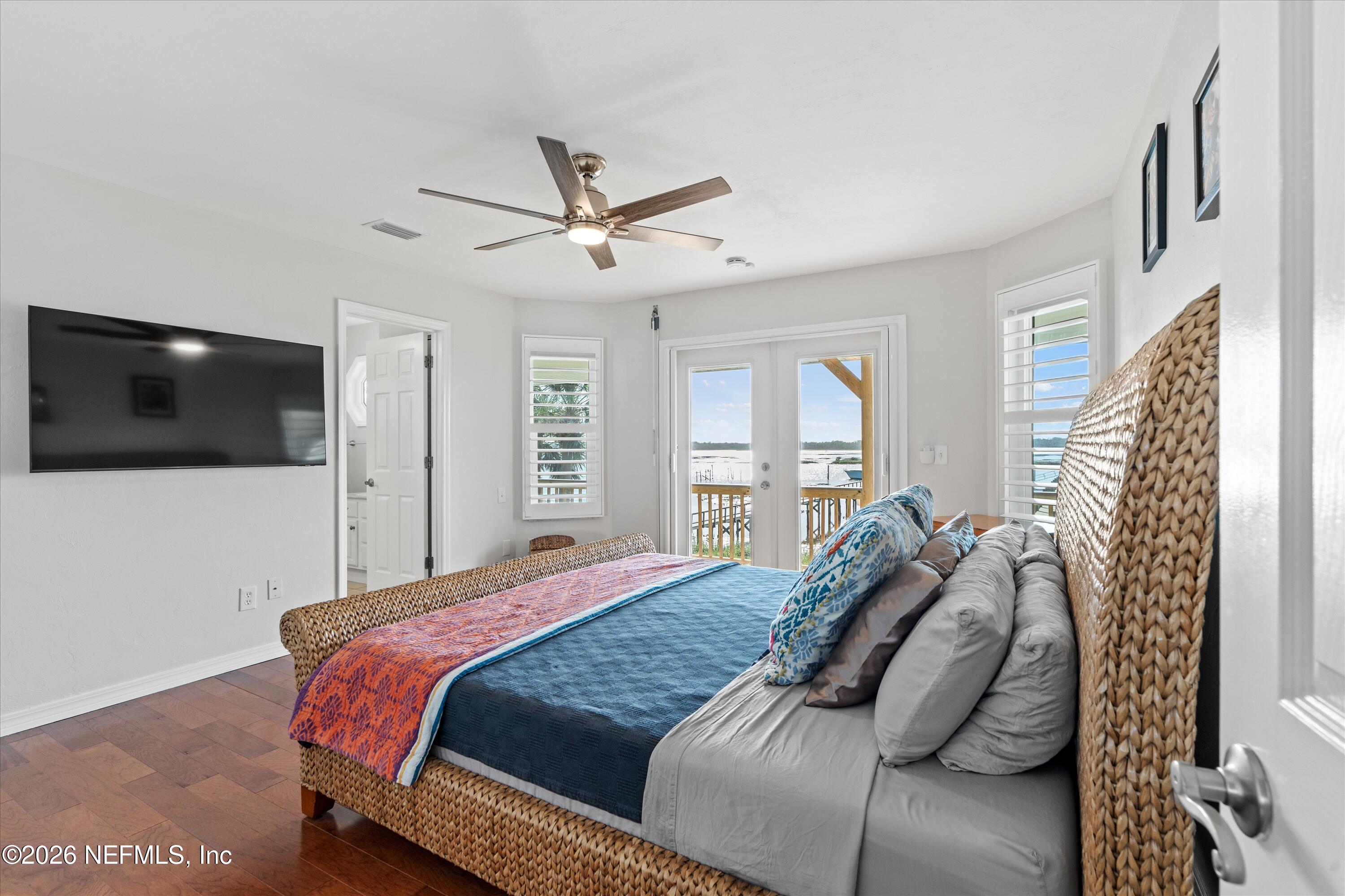 5532 Sunset Landing Circle St. Augustine, FL 32080 - Photo 38 of 43 a bedroom with a large bed and a flat screen tv