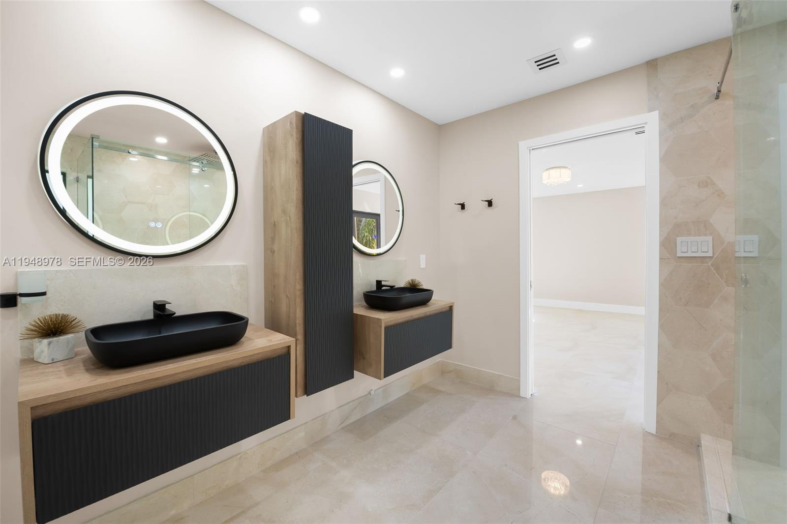 12820 Southwest 83rd Court Pinecrest, FL 33156 - Photo 16 of 38 a bathroom with a toilet a sink and a mirror