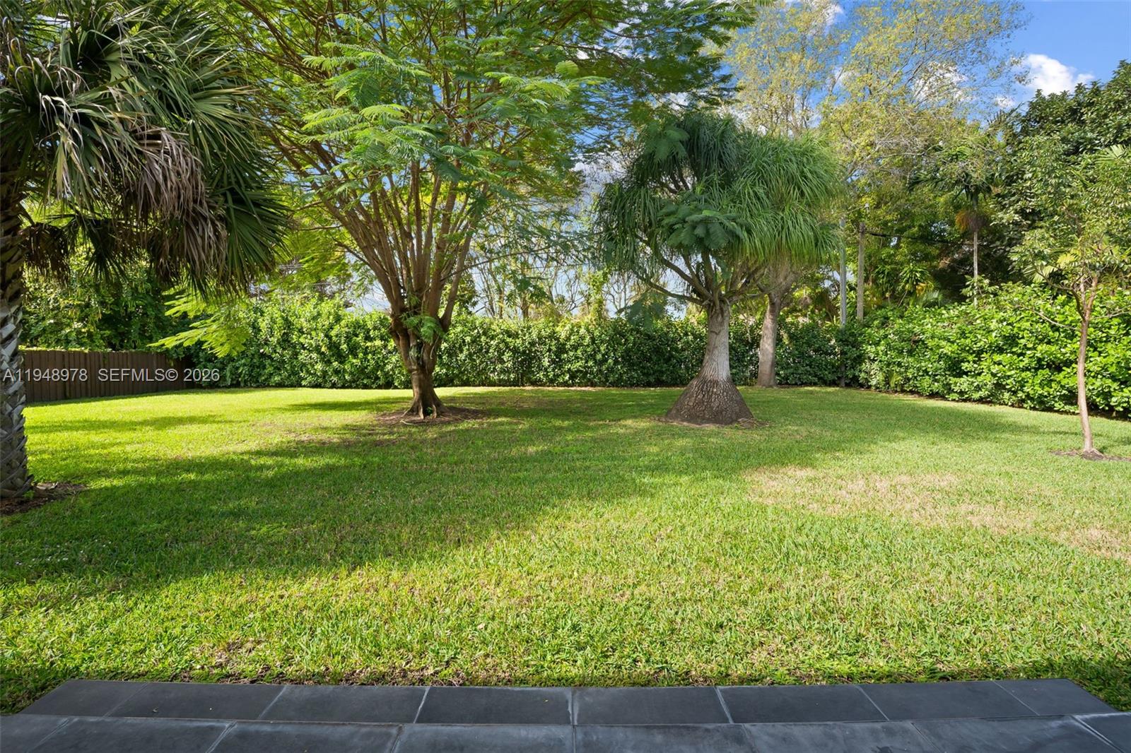 12820 Southwest 83rd Court Pinecrest, FL 33156 - Photo 27 of 38 a garden view with a fountain