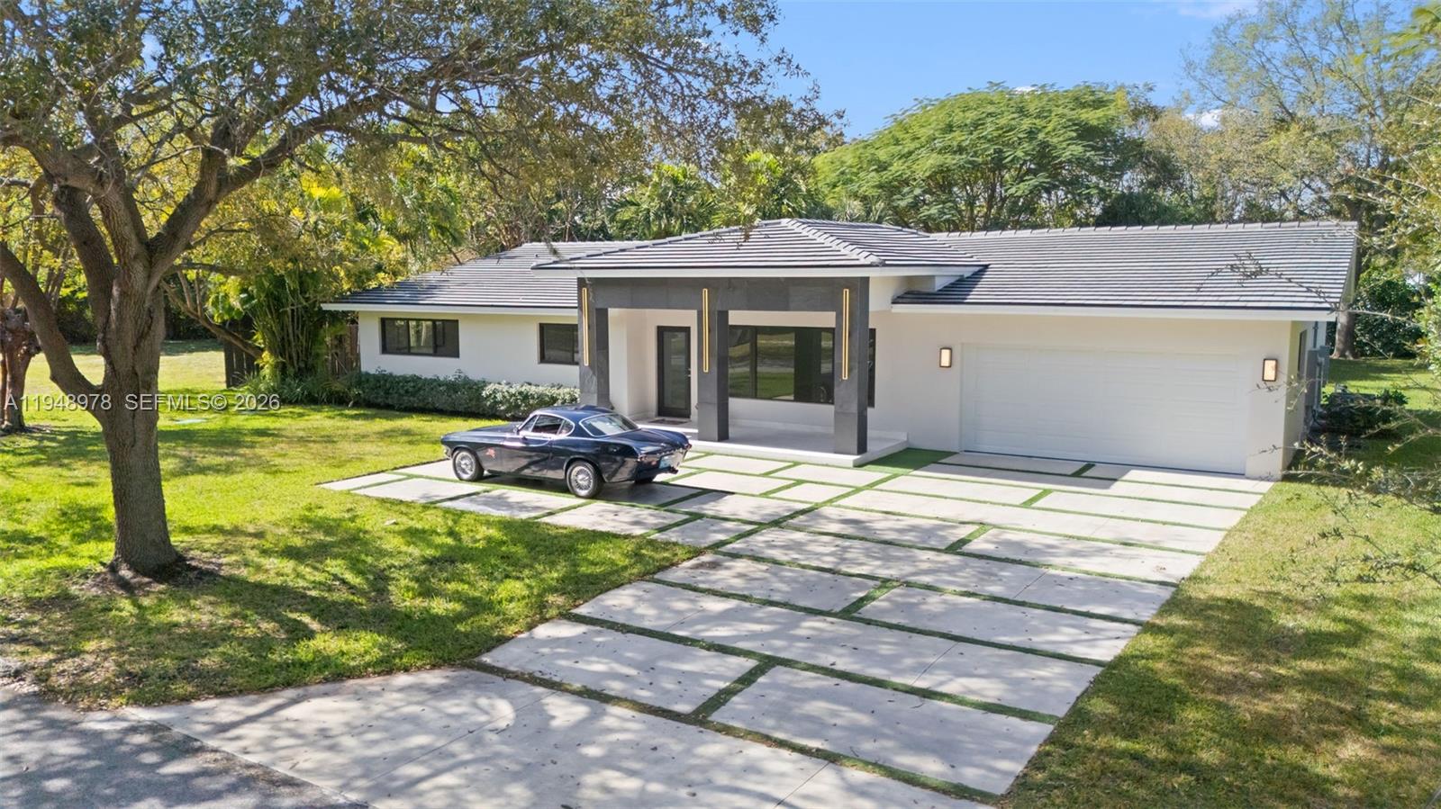12820 Southwest 83rd Court Pinecrest, FL 33156 - Photo 38 of 38 a view of a house with backyard sitting area and garden