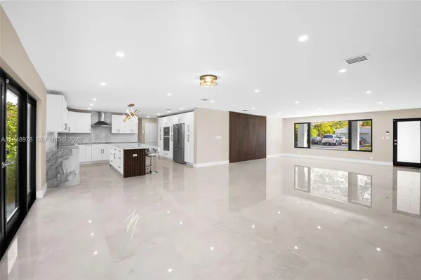 a view of kitchen with stainless steel appliances a refrigerator and a stove top oven