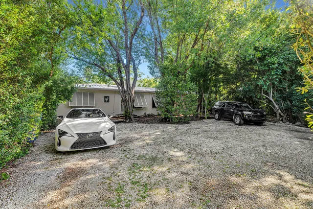 a car parked in front of a white house