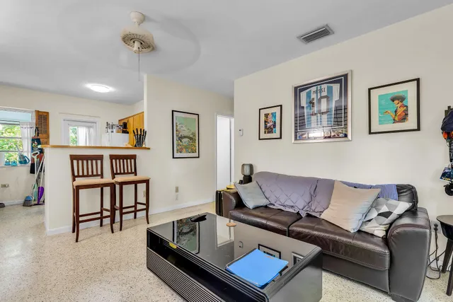 a living room with furniture and a book shelf