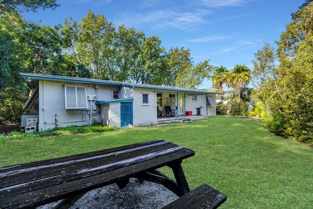 a view of a house with a yard and sitting area