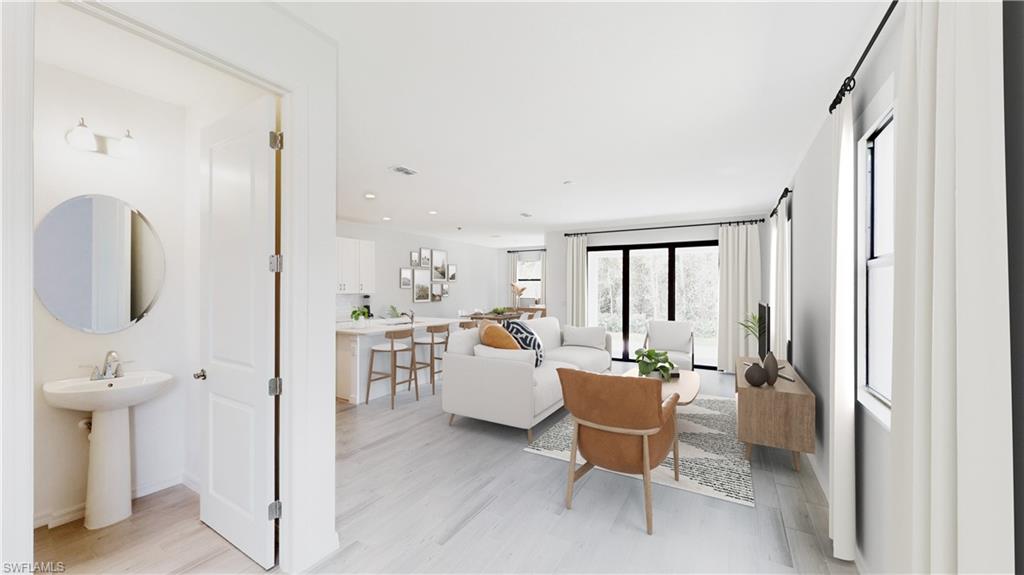 3134 Juniper Way Naples, FL 34112 - Photo 12 of 28 Living area featuring light wood-type flooring