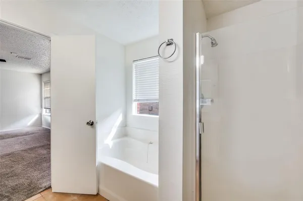 a bathroom with a bathtub and shower