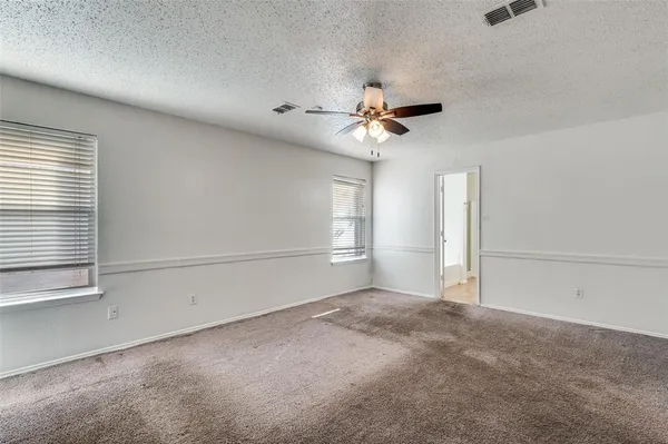 a view of a livingroom with a ceiling fan and window