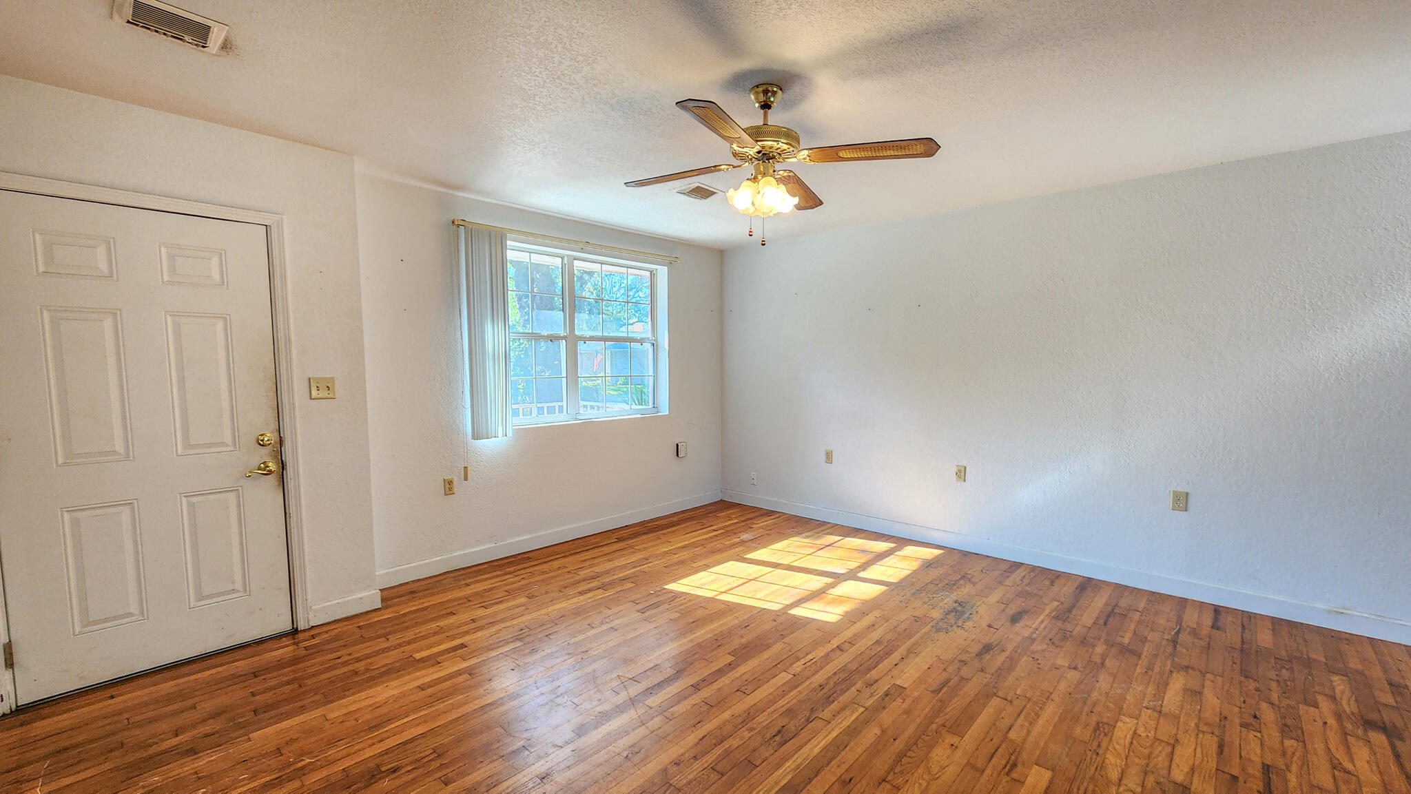 1200 Forest Heights Road Fort Walton Beach, FL 32547 - Photo 12 of 24 an empty room with wooden floor fan and windows