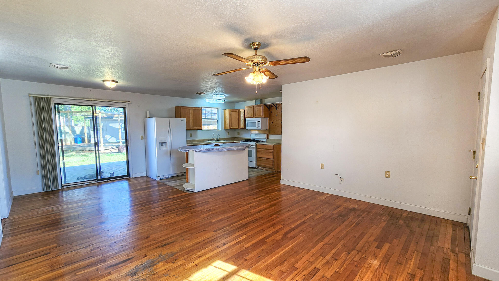 1200 Forest Heights Road Fort Walton Beach, FL 32547 - Photo 13 of 24 a view of a kitchen with wooden floor and a ceiling fan