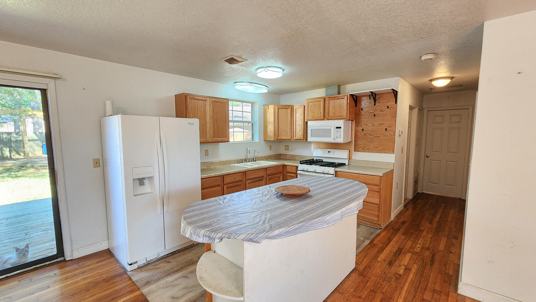 1200 Forest Heights Road Fort Walton Beach, FL 32547 - Photo 16 of 24 a kitchen with a refrigerator a sink and a stove top oven