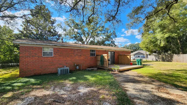 a view of a house with backyard and sitting area