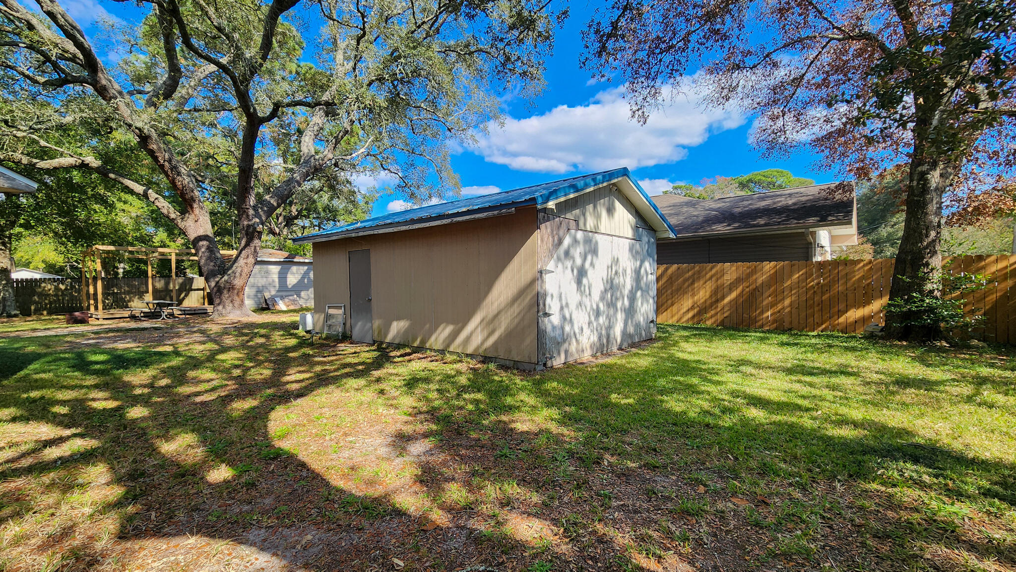 1200 Forest Heights Road Fort Walton Beach, FL 32547 - Photo 10 of 24 a backyard of a house with lots of green space