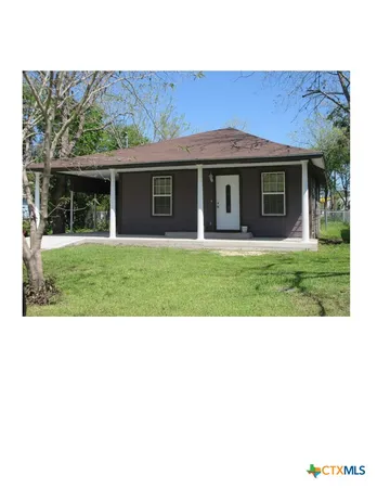 a view of a yard in front view of a house