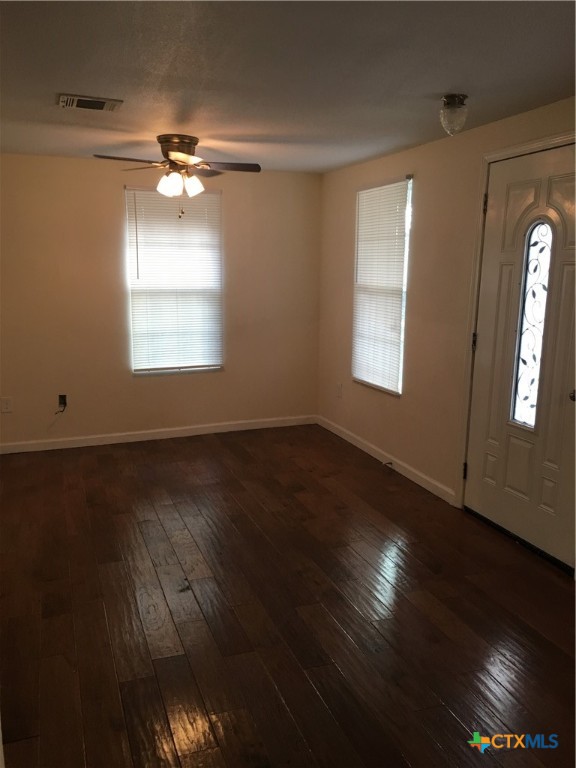 613 South Laurel Avenue Luling, TX 78648 - Photo 2 of 3 a view of an empty room with wooden floor and a window
