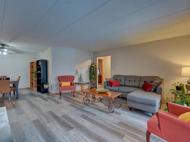 a living room with furniture and a wooden floor