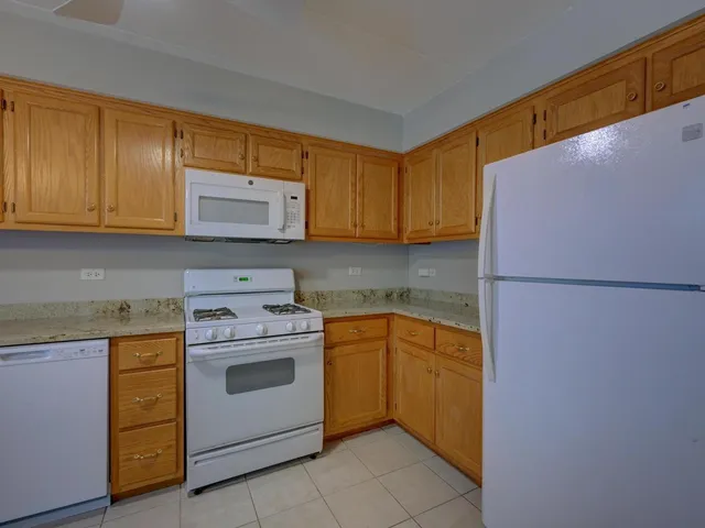 a kitchen with a stove top oven sink and cabinets