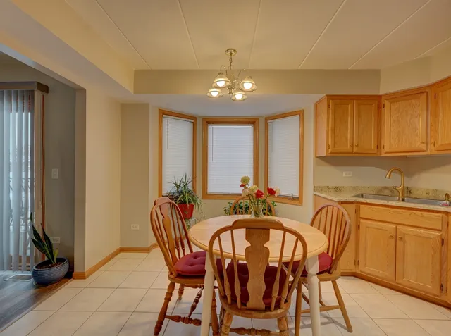 a dining room with furniture and chandelier