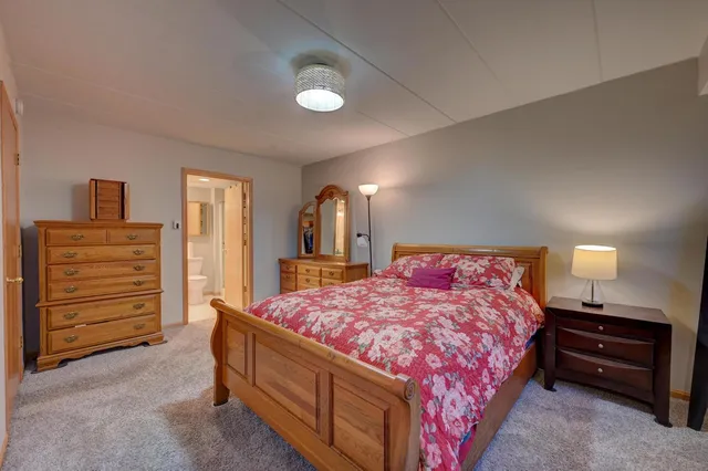 a bedroom with a bed and a dresser
