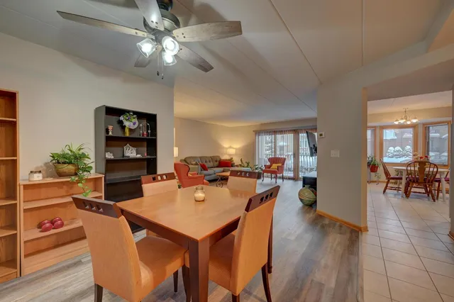 a dining room with furniture and wooden floor