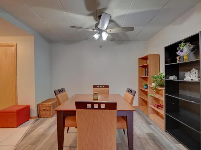 a view of a workspace with furniture and wooden floor