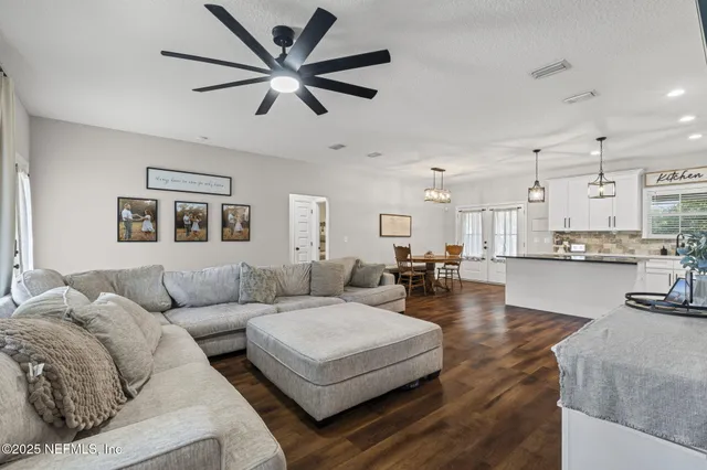 a living room with furniture and kitchen view