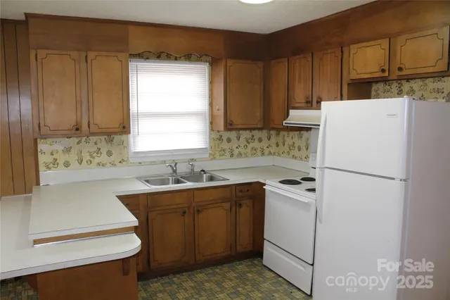 a kitchen with kitchen island a sink appliances and cabinets