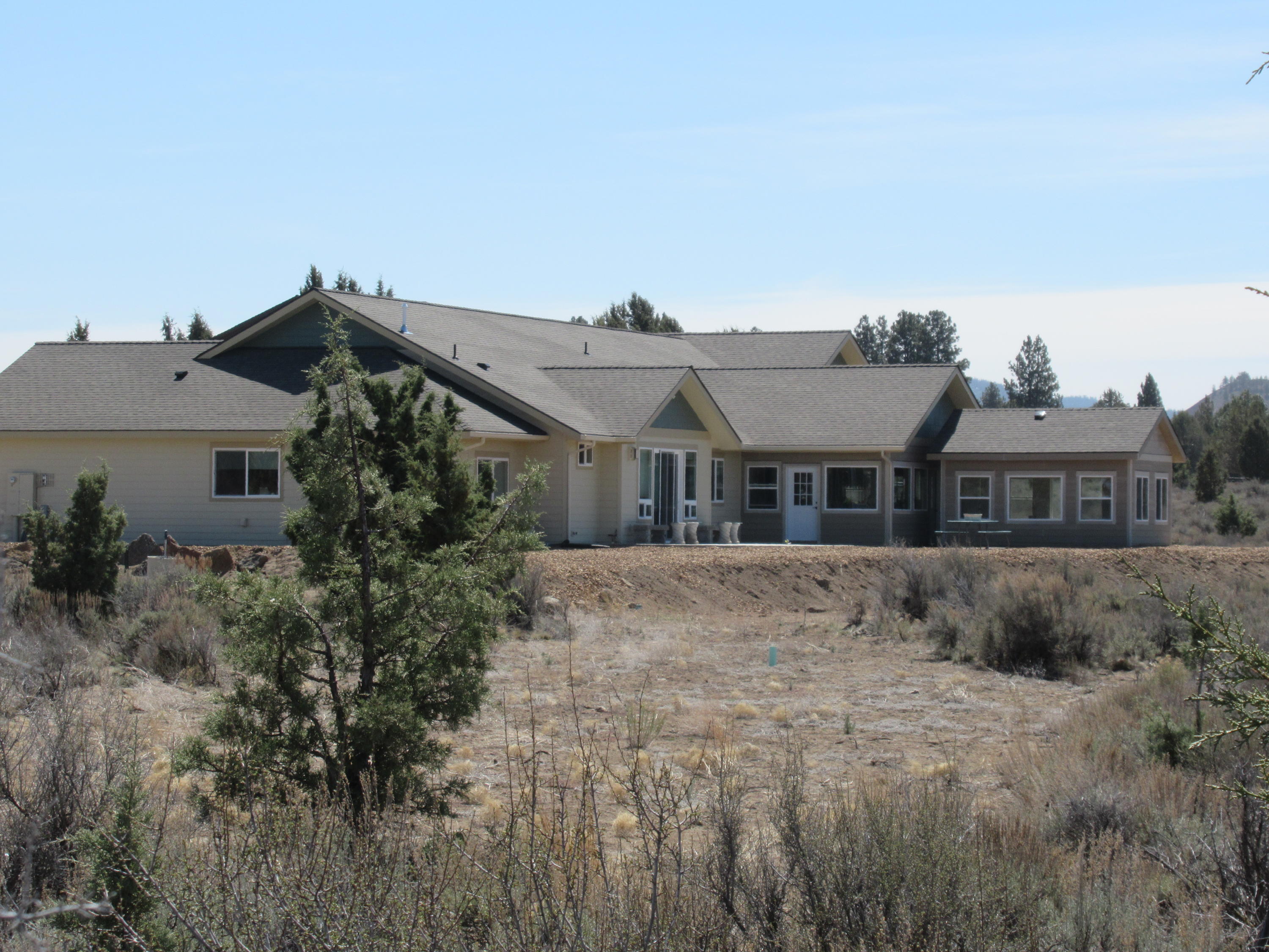 22063 Rickard Road Bend, OR 97702 - Photo 28 of 29 Side view shows enclosed patio, and smaller covered swim spa room. Patio has propane piped for BBQ and for heater or fireplace outdoors.