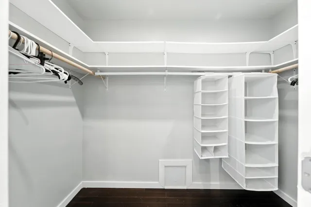 a view of walk in closet with empty racks