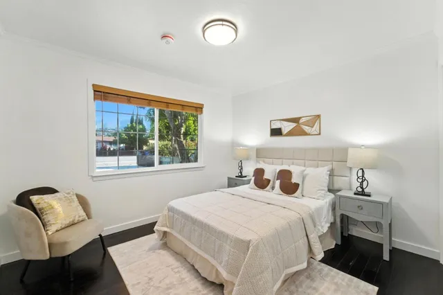 a bedroom with a bed and a chair