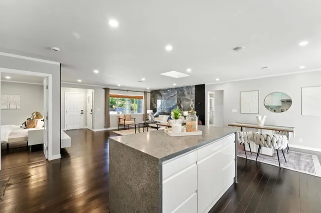 a large white kitchen with a table and chairs