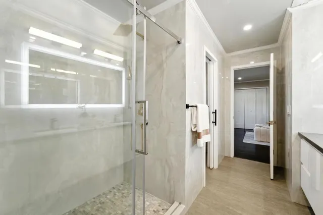 a bathroom with a shower and a glass door
