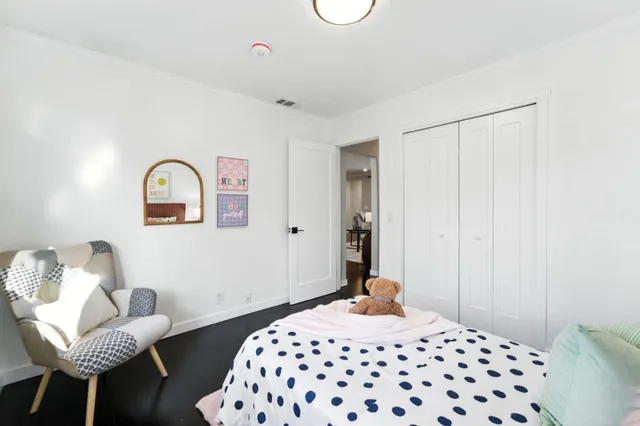 a bedroom with a bed and a chair