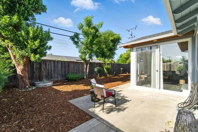 a backyard of a house with yard and outdoor seating