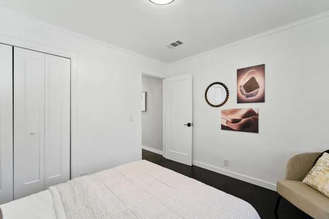 a bedroom with a bed and couch