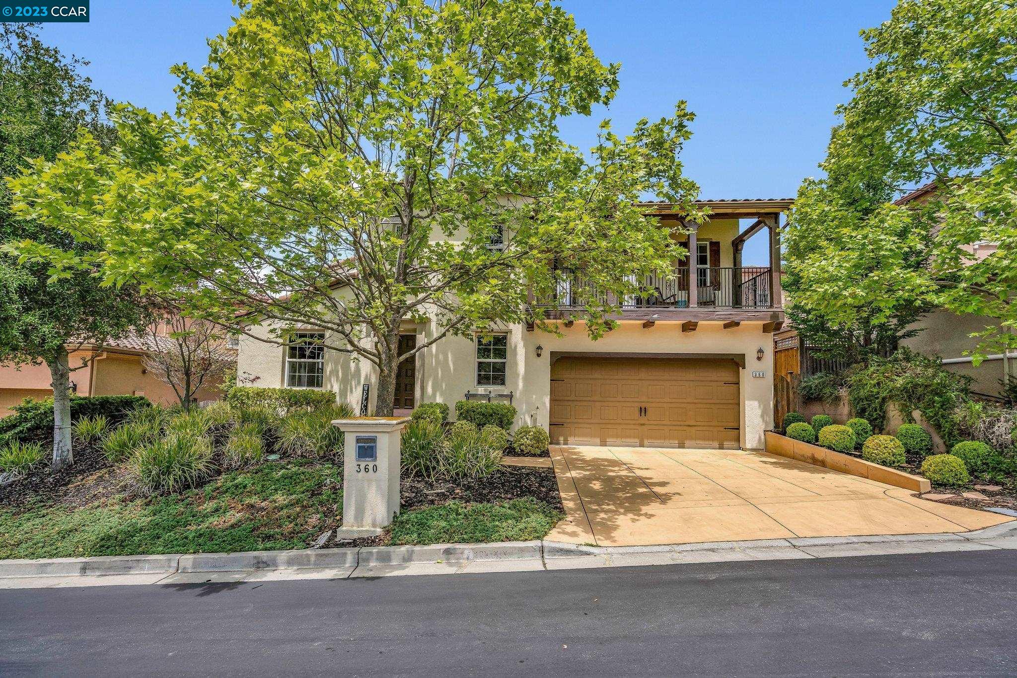 front view of a house with a tree