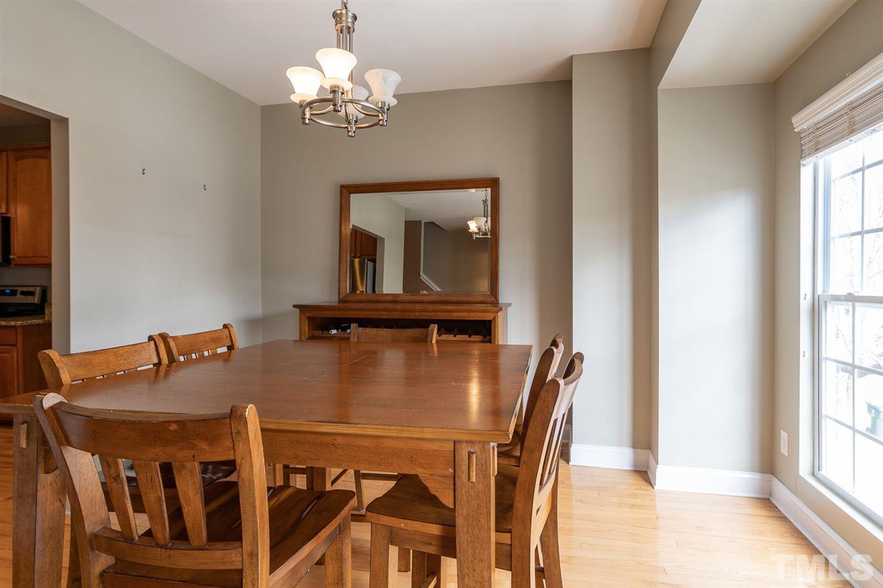 3111 Winding Waters Way Raleigh, NC 27614 - Photo 11 of 24 a view of a dining room with furniture and a chandelier