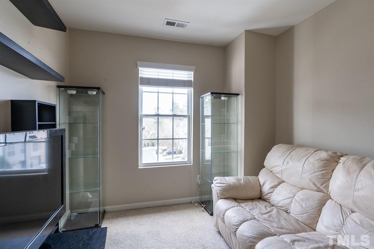 3111 Winding Waters Way Raleigh, NC 27614 - Photo 12 of 24 a living room with furniture and a flat screen tv