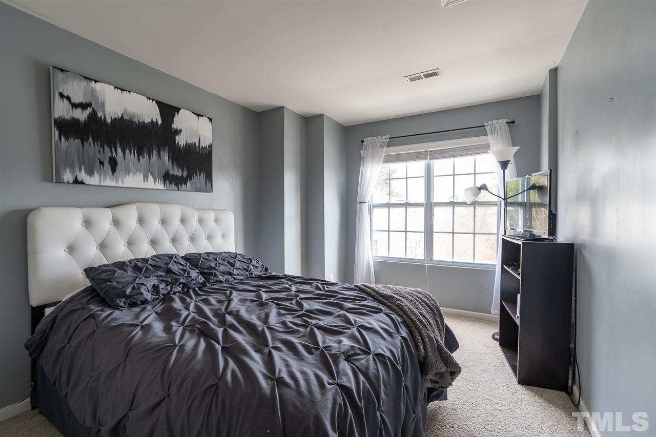 3111 Winding Waters Way Raleigh, NC 27614 - Photo 13 of 24 a bed sitting in a bedroom next to a window
