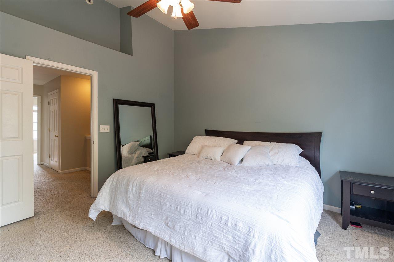 3111 Winding Waters Way Raleigh, NC 27614 - Photo 16 of 24 a bedroom with a bed and a tv