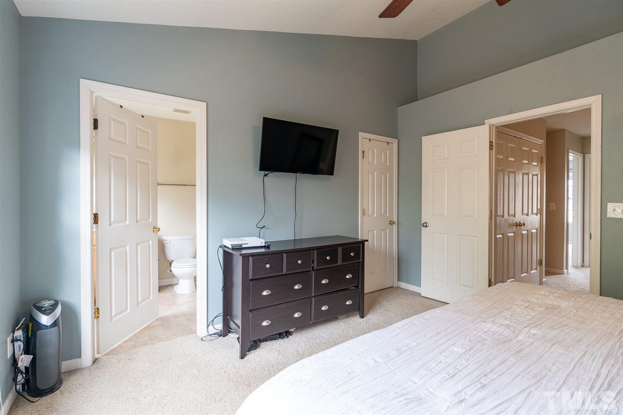 3111 Winding Waters Way Raleigh, NC 27614 - Photo 17 of 24 a bedroom with a bed and a television