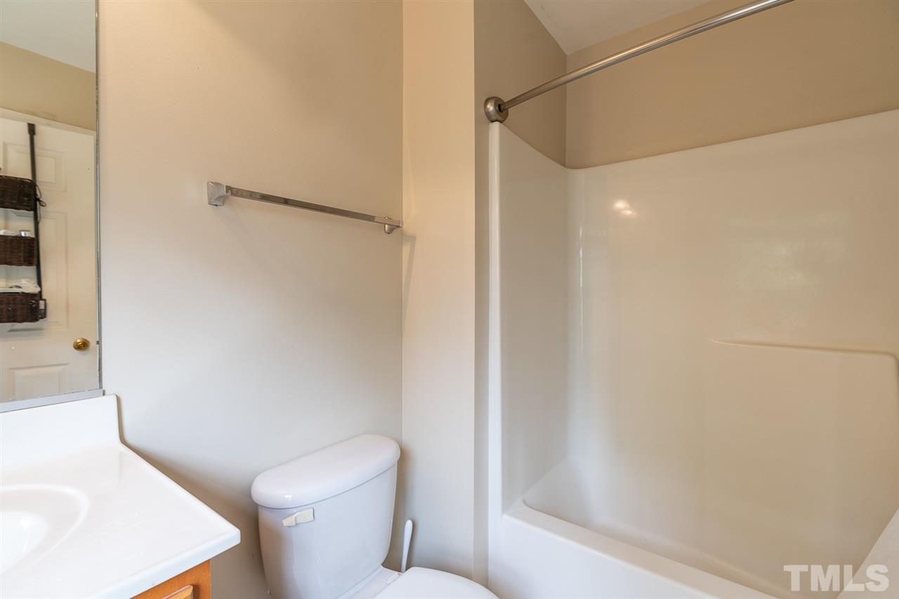 3111 Winding Waters Way Raleigh, NC 27614 - Photo 18 of 24 a white toilet sitting next to a bath tub