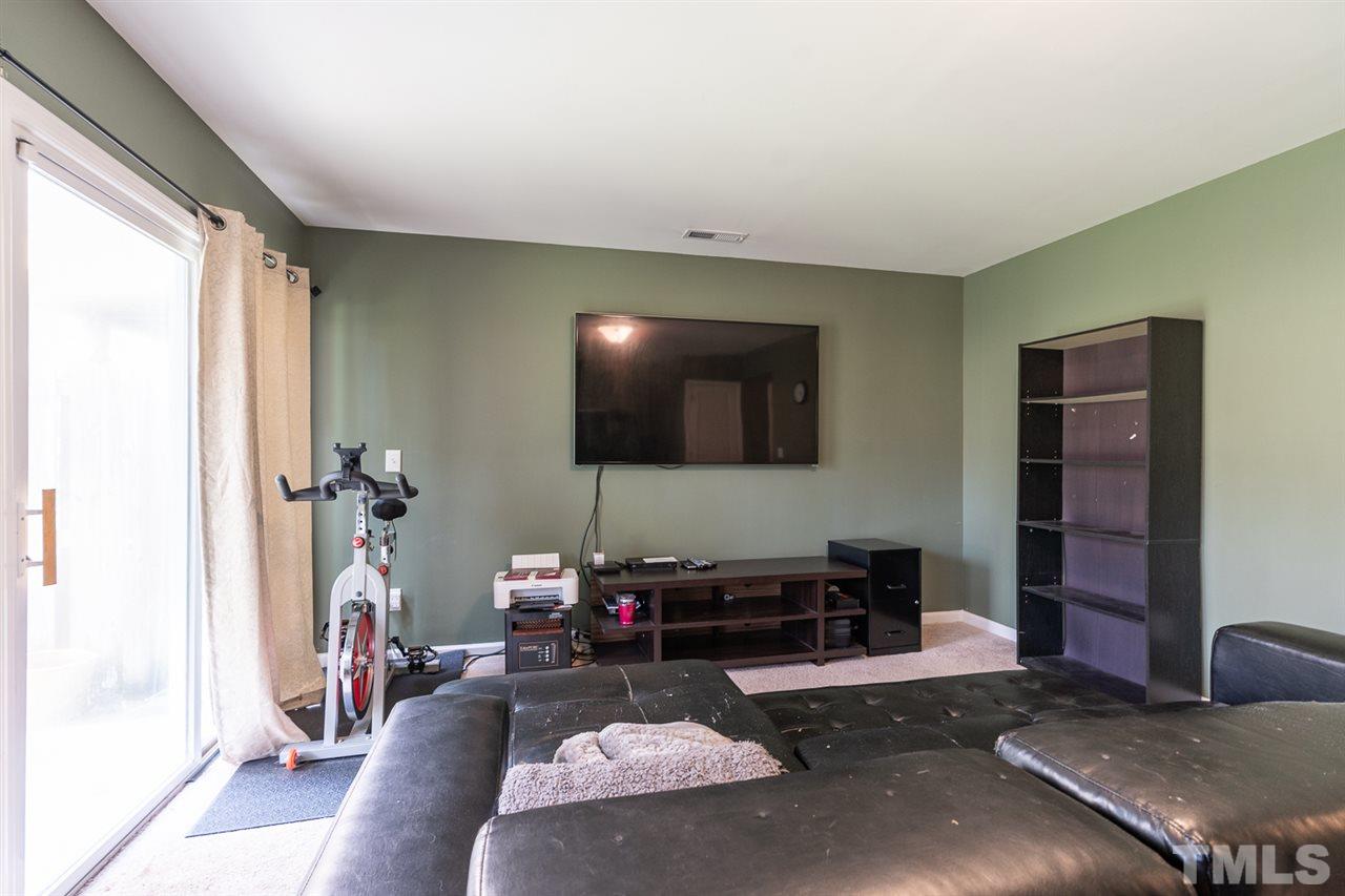 3111 Winding Waters Way Raleigh, NC 27614 - Photo 20 of 24 a living room with furniture and a flat screen tv