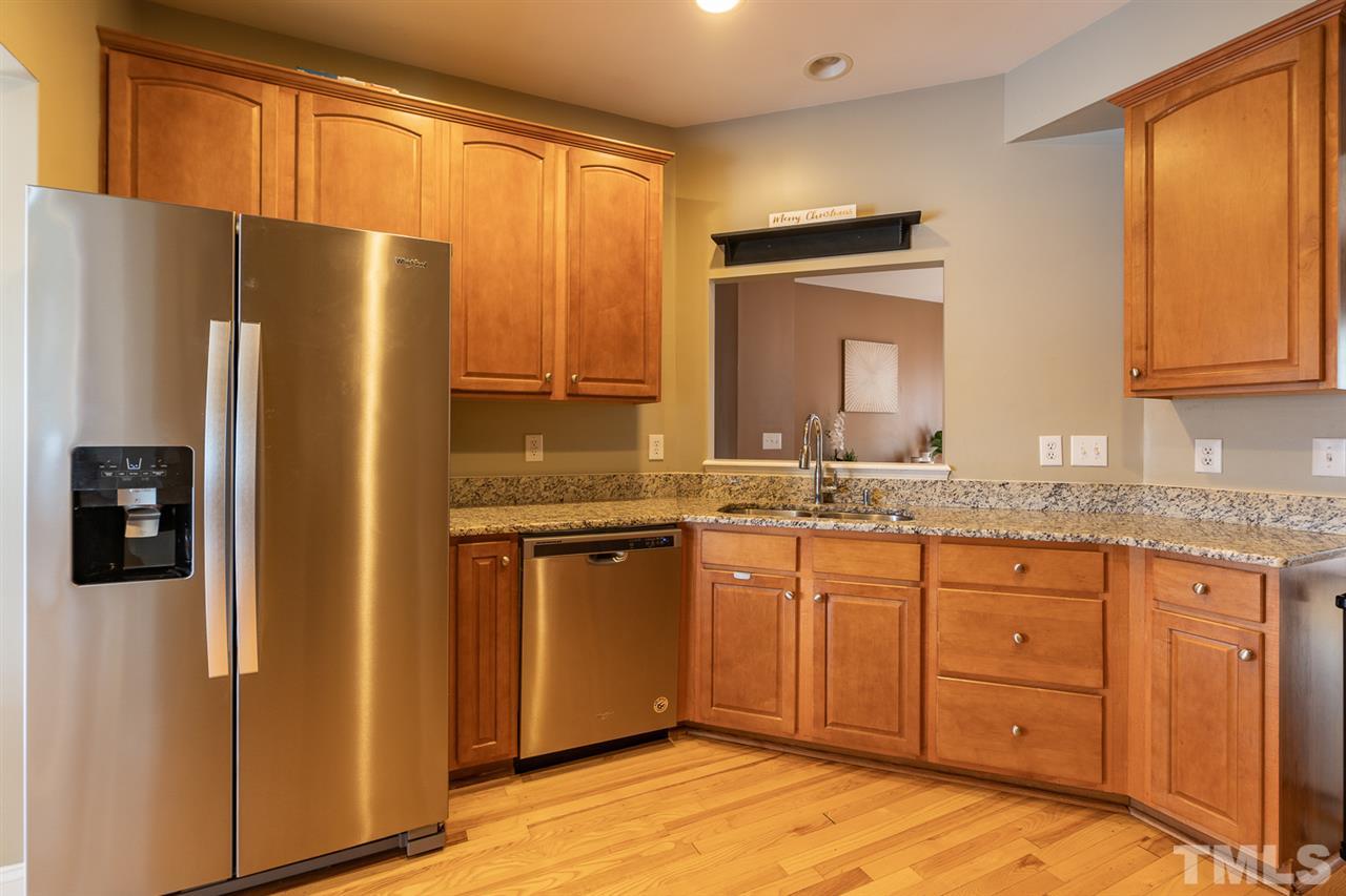 3111 Winding Waters Way Raleigh, NC 27614 - Photo 3 of 24 a kitchen with stainless steel appliances granite countertop a refrigerator and a sink