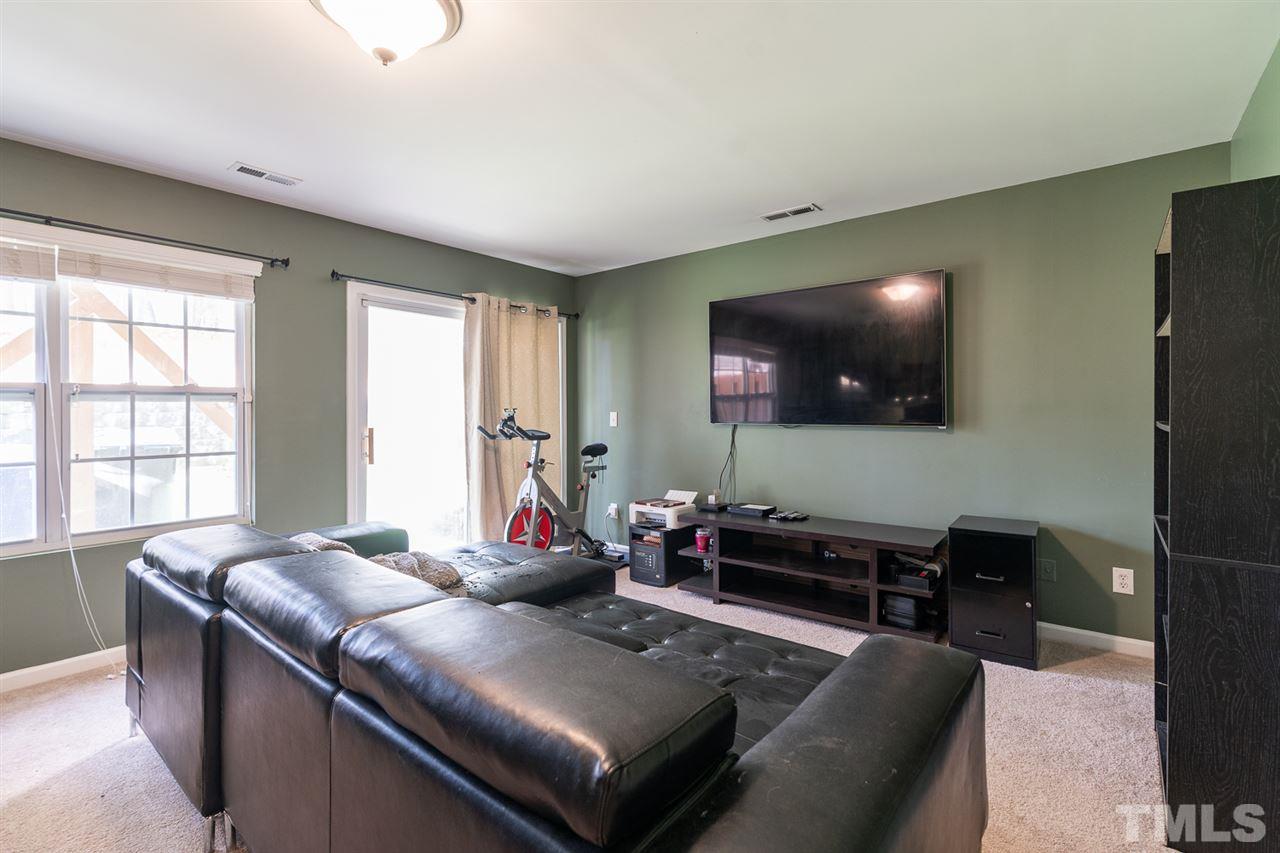 3111 Winding Waters Way Raleigh, NC 27614 - Photo 21 of 24 a living room with furniture and a flat screen tv