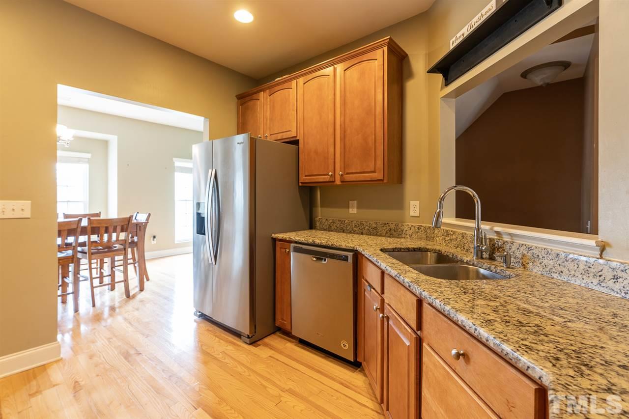 3111 Winding Waters Way Raleigh, NC 27614 - Photo 4 of 24 a kitchen with granite countertop a sink cabinets and stainless steel appliances