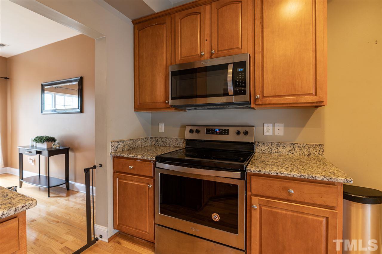 3111 Winding Waters Way Raleigh, NC 27614 - Photo 5 of 24 a kitchen with granite countertop a stove and a microwave
