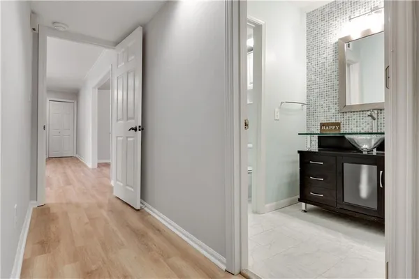 a view of a bathroom with a sink and a mirror
