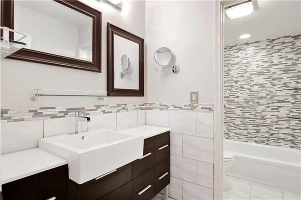 a bathroom with a sink a mirror and a bathtub