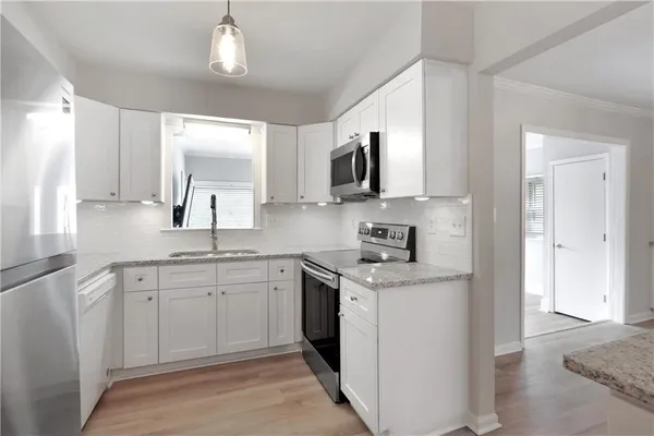 a kitchen with a sink stove and microwave